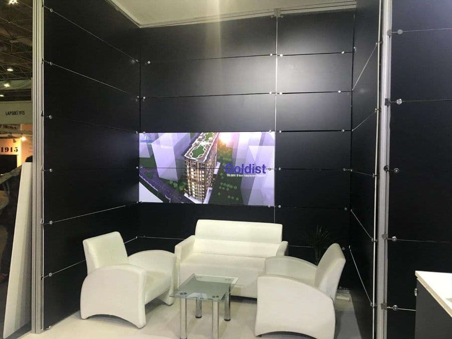 a room with white chairs and a table